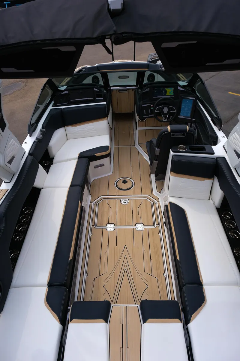 Slide: The Image of 2025 Supra SE450 boat interior with sleek seating and modern dashboard design. - 11