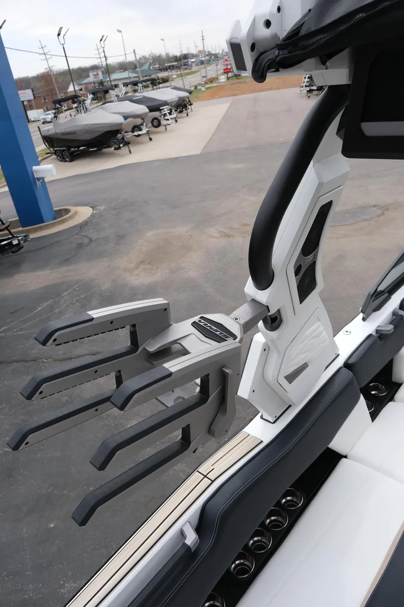 Slide: The Image of 2025 Supra SE450 boat with advanced wakeboard rack and sleek interior design. - 14