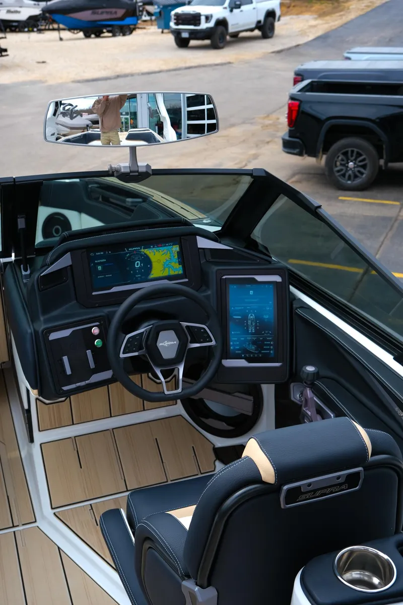 Slide: The Image of 2025 Supra SE450 boat interior with advanced navigation displays and sleek steering wheel design. - 15