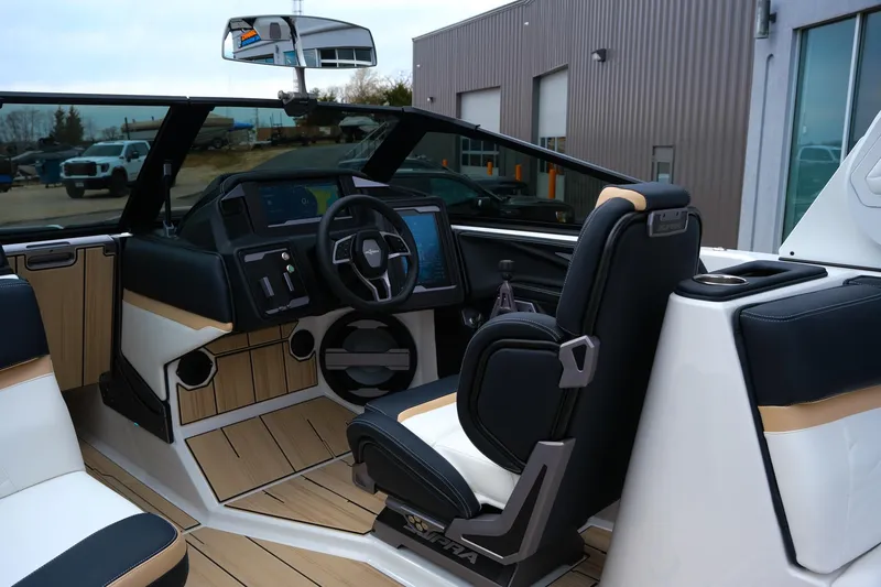 Slide: The Image of 2025 Supra SE450 boat interior with modern dashboard and sleek black seating. - 17