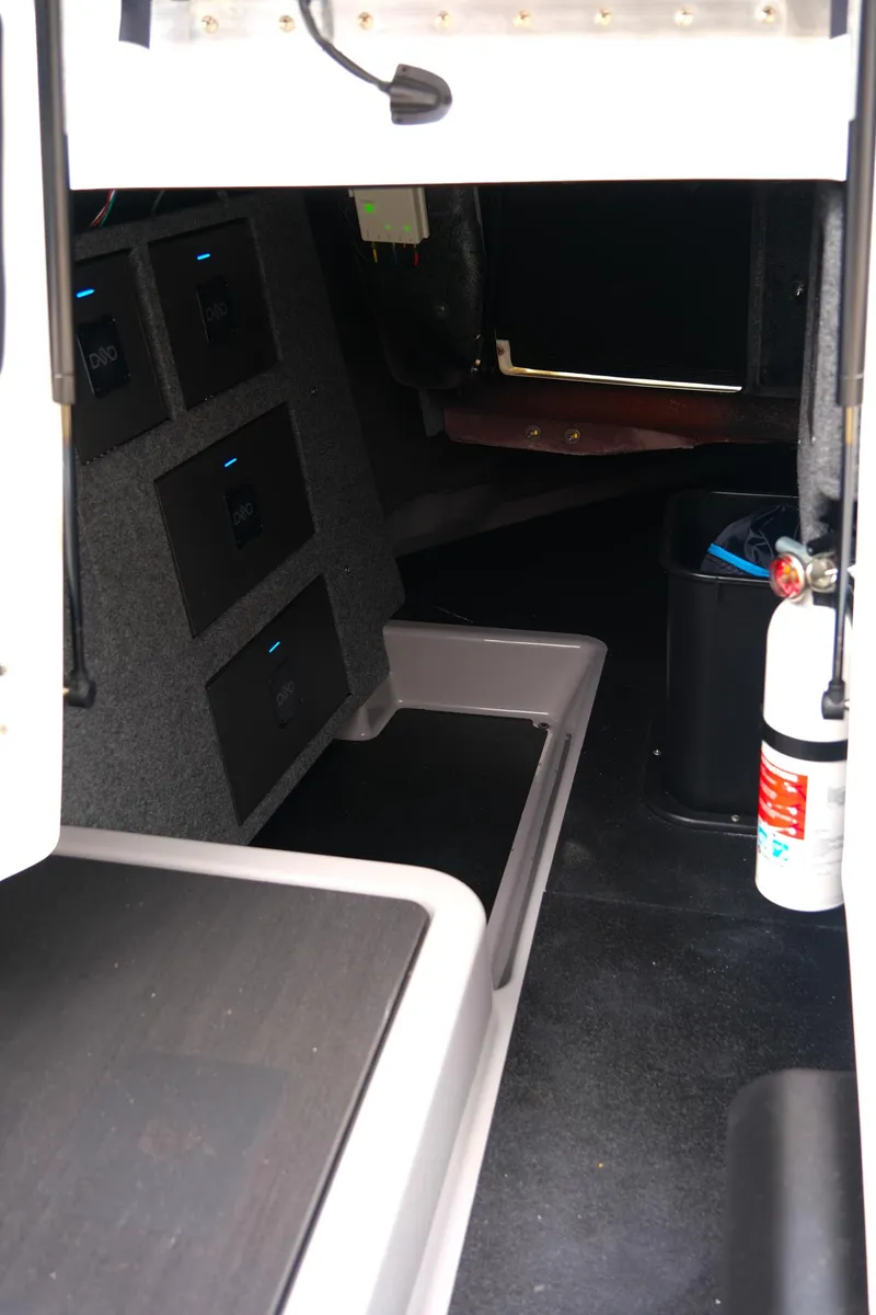 Slide: The Image of Interior of 2025 Supra SE450 boat with storage compartments and safety equipment. - 19