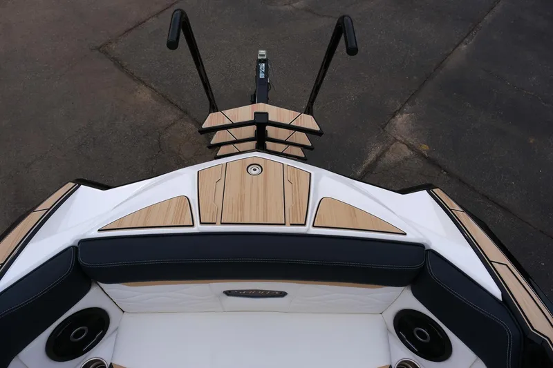 Slide: The Image of 2025 Supra SE450 boat bow with sleek design and wood accents. - 24