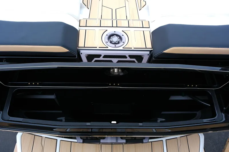 Slide: The Image of 2025 Supra SE450 boat interior with sleek black and wood accents, showcasing storage compartment. - 32