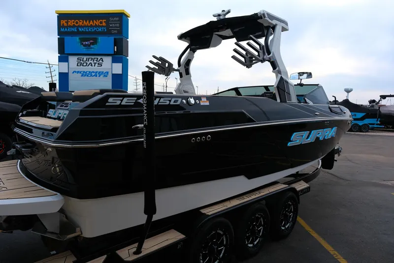 Slide: The Image of 2025 Supra SE450 boat on trailer at Performance Marine Watersports dealership. - 33