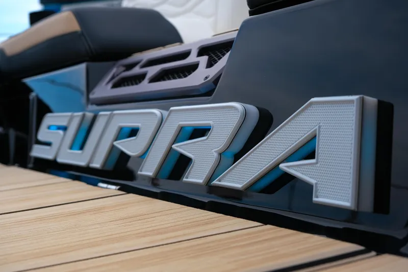 Slide: The Image of 2025 Supra SE450 boat logo on sleek black surface with wooden deck. - 5