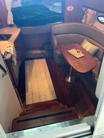 Slide: The Image of Interior of 2009 Crownline 340 CR boat with cozy seating and wooden table. - 14