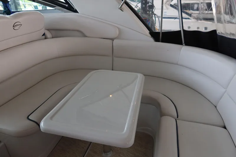 Slide: The Image of 2009 Crownline 340 CR boat interior with white leather seating and table. - 15