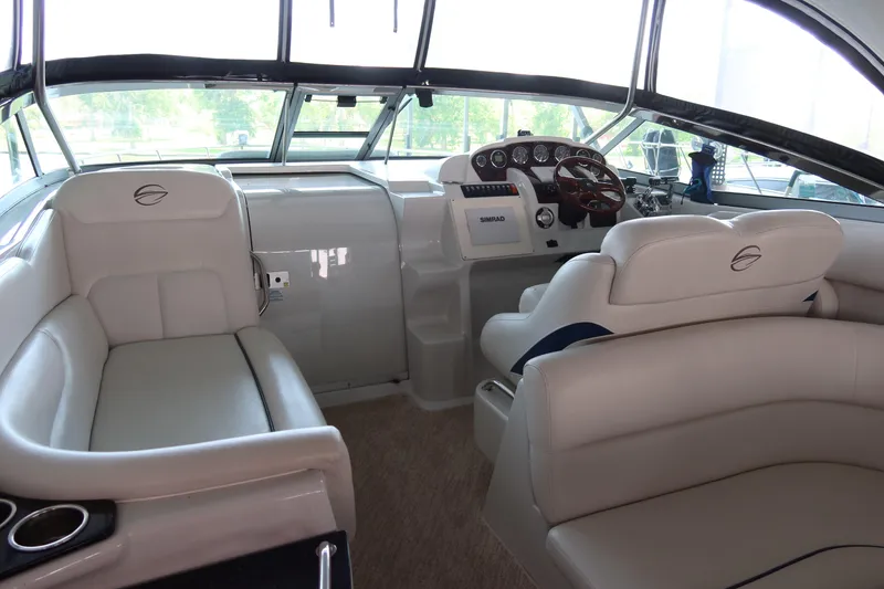 Slide: The Image of 2009 Crownline 340 CR boat interior with plush seating and modern dashboard. - 16