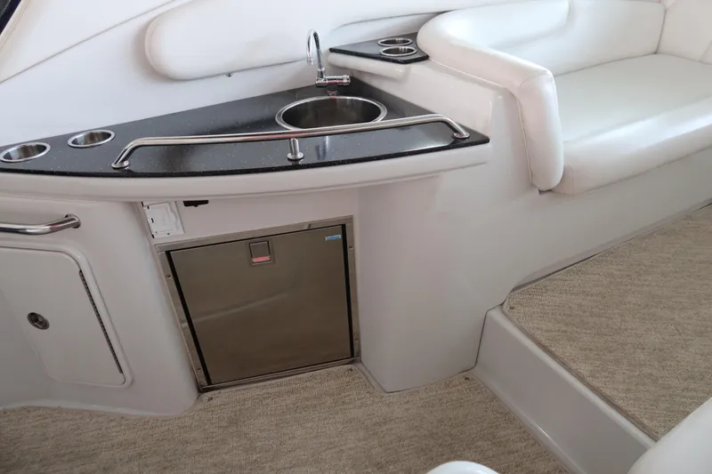 Slide: The Image of 2009 Crownline 340 CR yacht interior with kitchenette, sink, and seating area. - 17