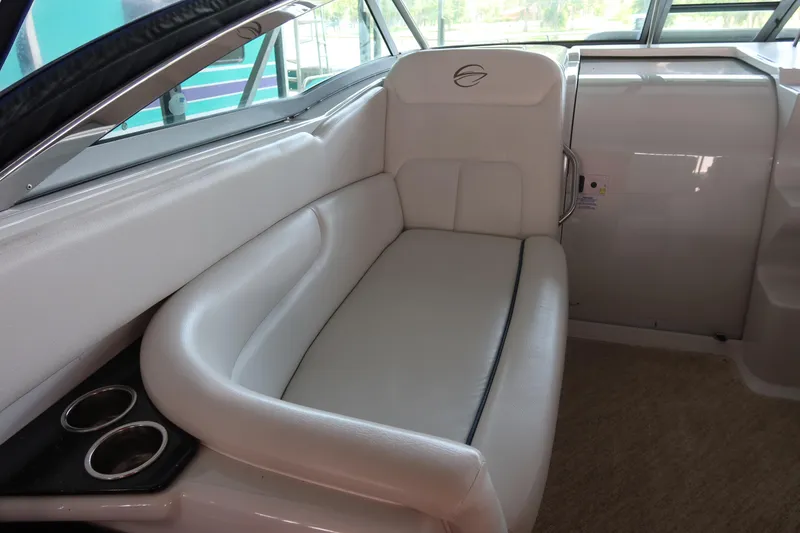 Slide: The Image of 2009 Crownline 340 CR boat interior with white leather seating and cup holders. - 18