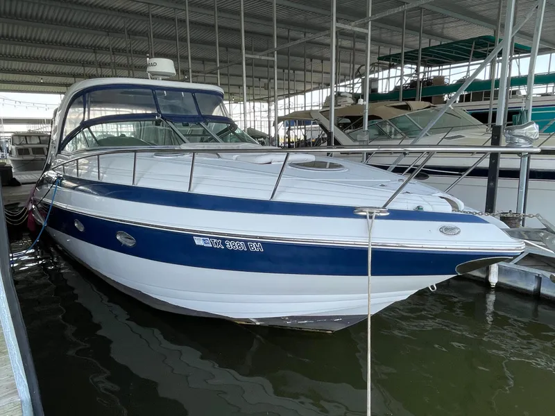Slide: The Image of 2009 Crownline 340 CR boat docked in a covered marina. - 2