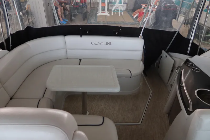 Slide: The Image of 2009 Crownline 340 CR boat interior with white seating and table. - 20