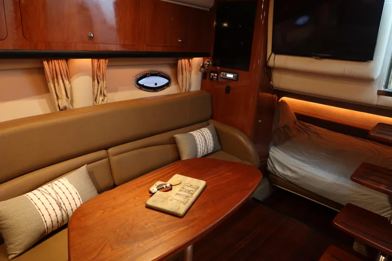 Slide: The Image of Luxurious interior of 2009 Crownline 340 CR yacht with cozy seating and elegant wood finishes. - 24