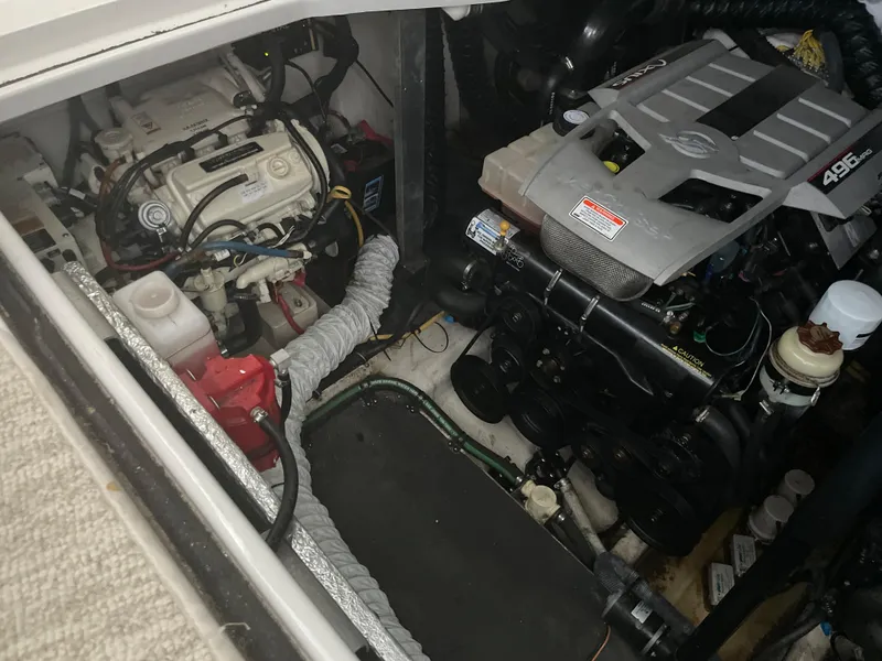 Slide: The Image of Engine compartment of a 2009 Crownline 340 CR boat, showcasing mechanical components. - 32