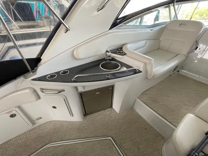 Slide: The Image of 2009 Crownline 340 CR boat interior with seating, sink, and storage. - 34