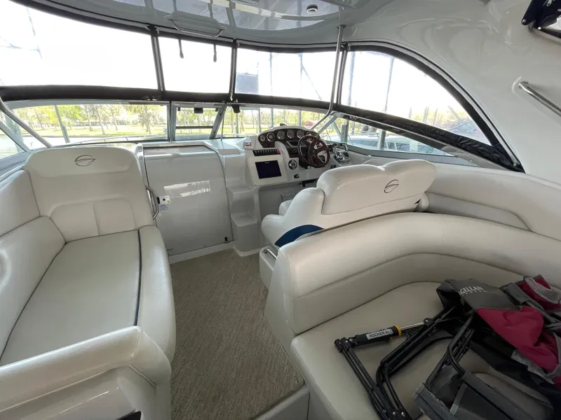 Slide: The Image of 2009 Crownline 340 CR boat interior with plush seating and modern dashboard. - 35