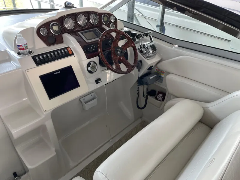 Slide: The Image of 2009 Crownline 340 CR boat cockpit with steering wheel and control panel. - 36