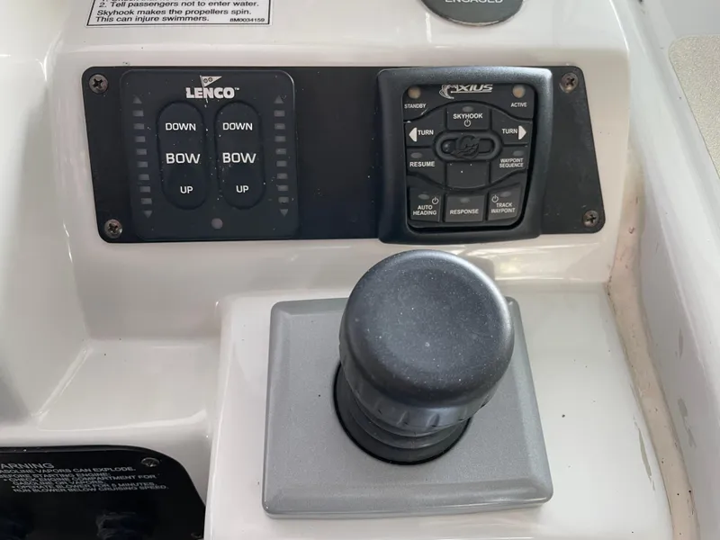 Slide: The Image of Control panel of a 2009 Crownline 340 CR boat with joystick and trim tabs. - 39