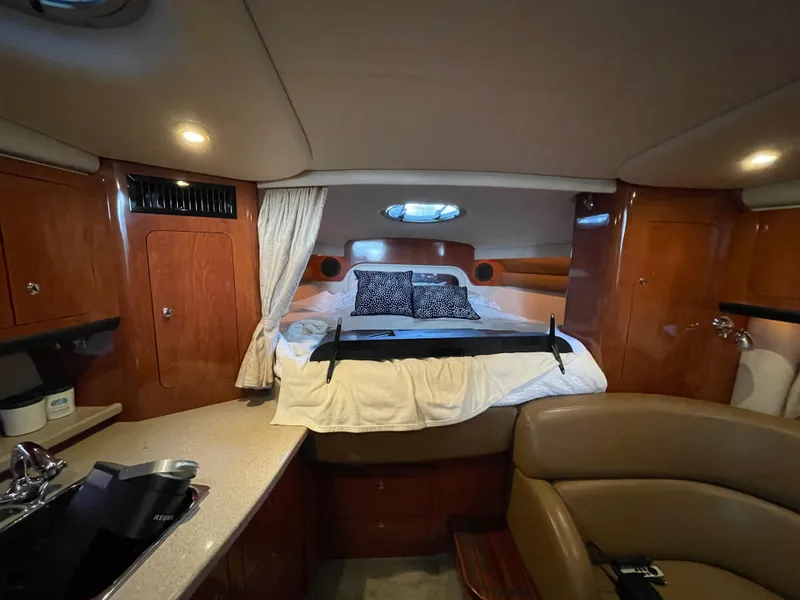 Slide: The Image of Luxurious interior of a 2009 Crownline 340 CR yacht with cozy bed and elegant wood finish. - 43