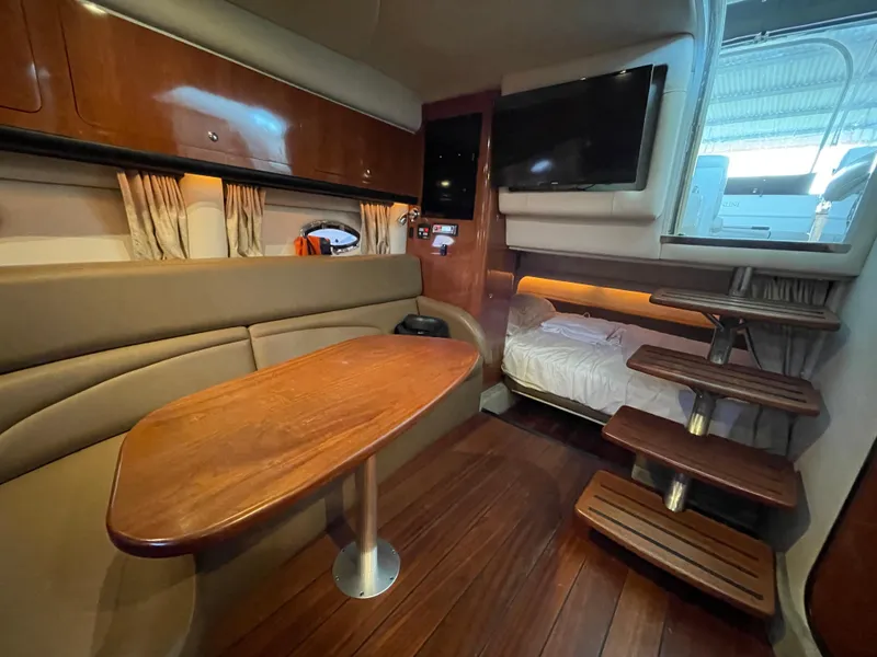 Slide: The Image of 2009 Crownline 340 CR cabin interior with wood finishes, seating, table, and stairs. - 45