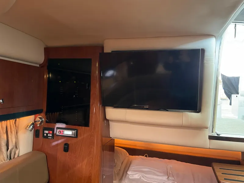 Slide: The Image of Interior of 2009 Crownline 340 CR boat with TV and wooden paneling. - 46