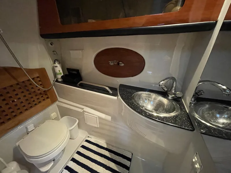 Slide: The Image of 2009 Crownline 340 CR bathroom with sink, toilet, and striped rug. - 47