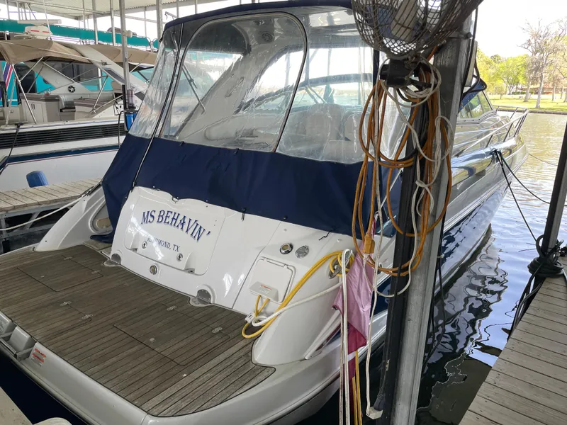 Slide: The Image of 2009 Crownline 340 CR boat docked, featuring a covered deck and visible marina surroundings. - 5