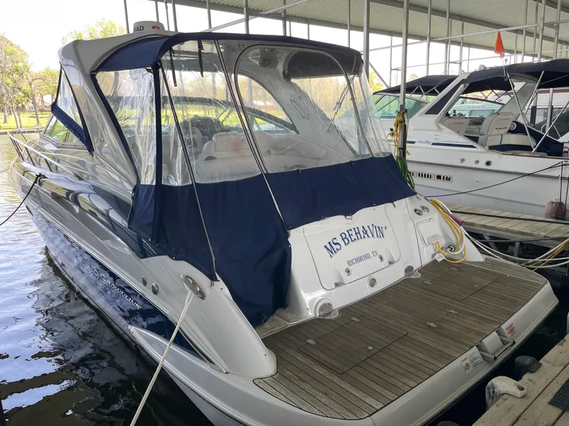 Slide: The Image of 2009 Crownline 340 CR boat docked with protective cover, rear view. - 6