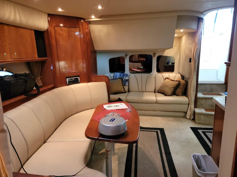 Slide: The Image of Interior of 2004 Cruisers Yachts 370 Express with elegant seating and wooden finishes. - 11