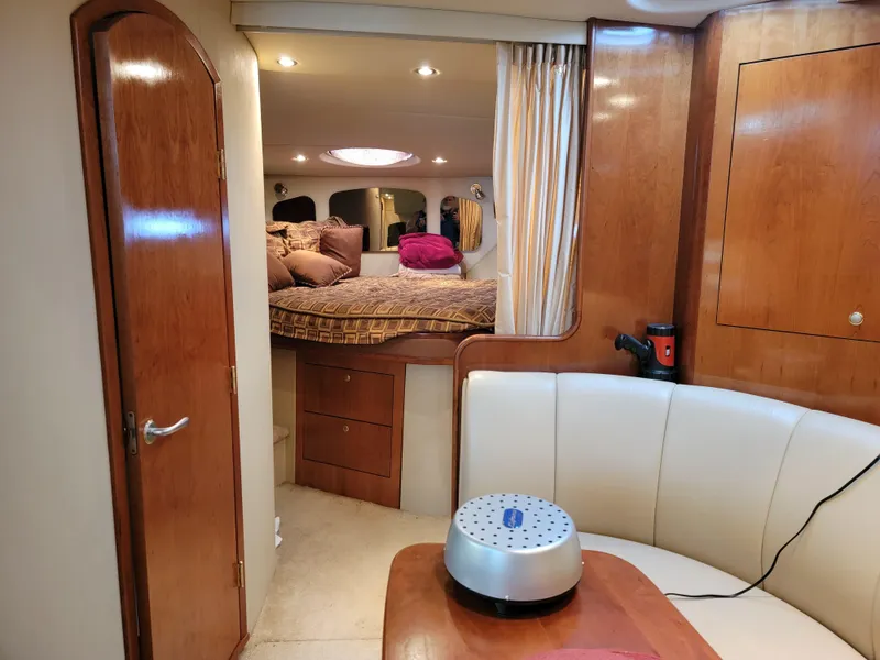 Slide: The Image of Interior of 2004 Cruisers Yachts 370 Express, featuring cozy seating and a well-appointed cabin. - 12