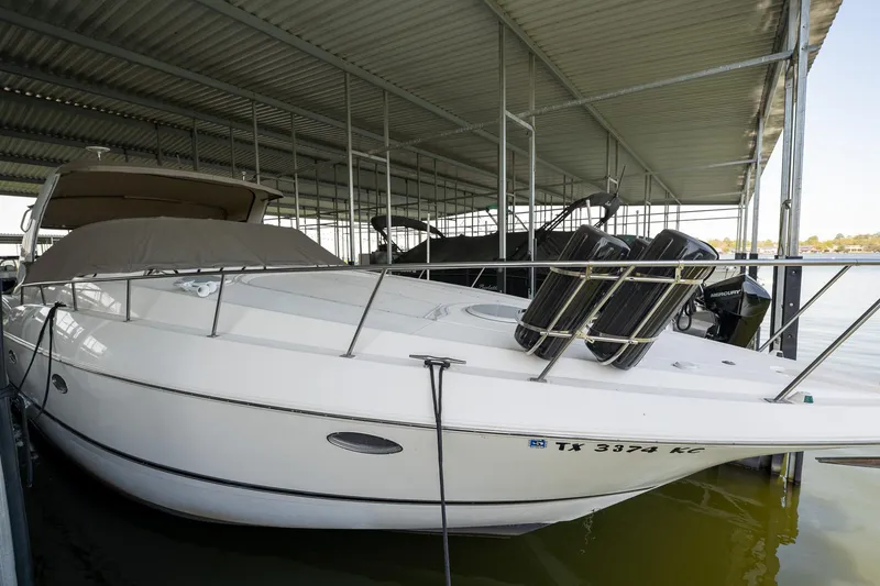 Slide: The Image of 2004 Cruisers Yachts 370 Express docked under a covered marina. - 19