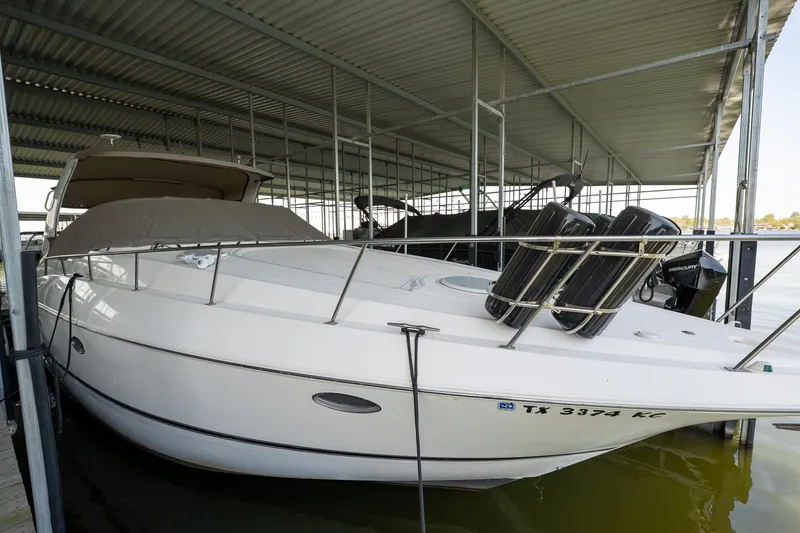 Slide: The Image of 2004 Cruisers Yachts 370 Express docked under a covered marina. - 20