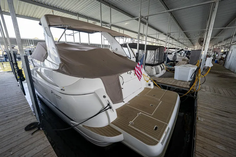 Slide: The Image of 2004 Cruisers Yachts 370 Express docked under a covered marina. - 21