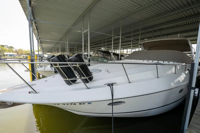 Slide: The Image of 2004 Cruisers Yachts 370 Express docked under covered marina. - 22