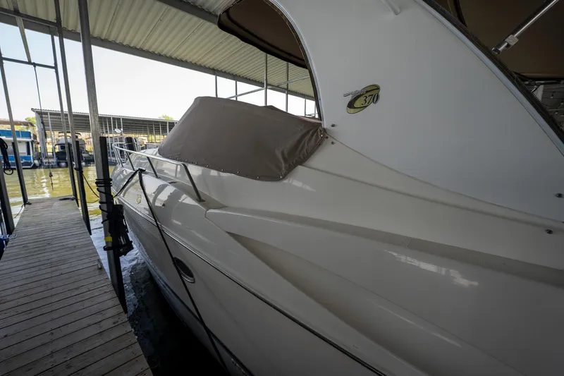 Slide: The Image of 2004 Cruisers Yachts 370 Express docked in a covered marina. - 23