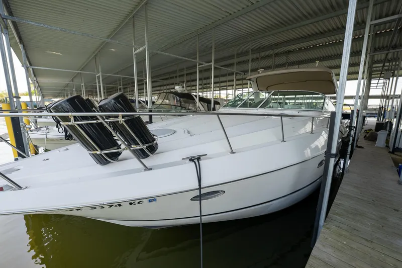 Slide: The Image of 2004 Cruisers Yachts 370 Express docked in a covered marina. - 28