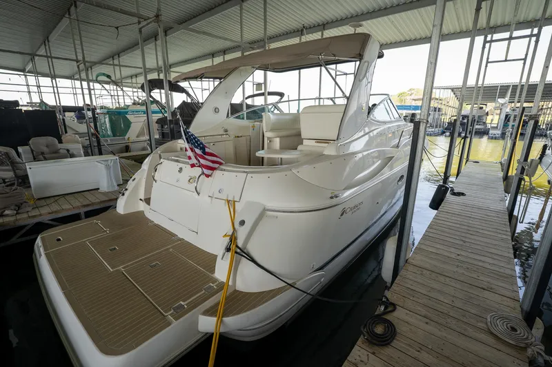 Slide: The Image of 2004 Cruisers Yachts 370 Express docked in a covered marina. - 30