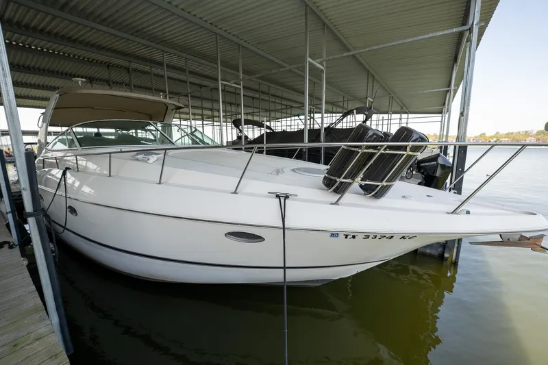 Slide: The Image of 2004 Cruisers Yachts 370 Express docked in a covered marina. - 32