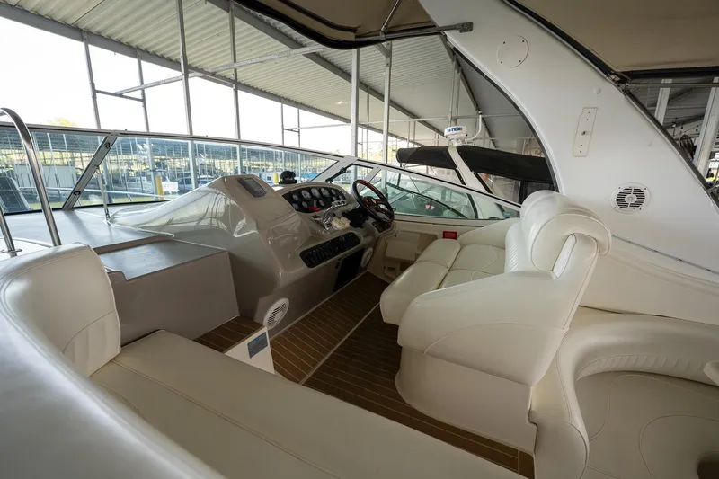 Slide: The Image of 2004 Cruisers Yachts 370 Express interior with white seating and modern dashboard. - 35