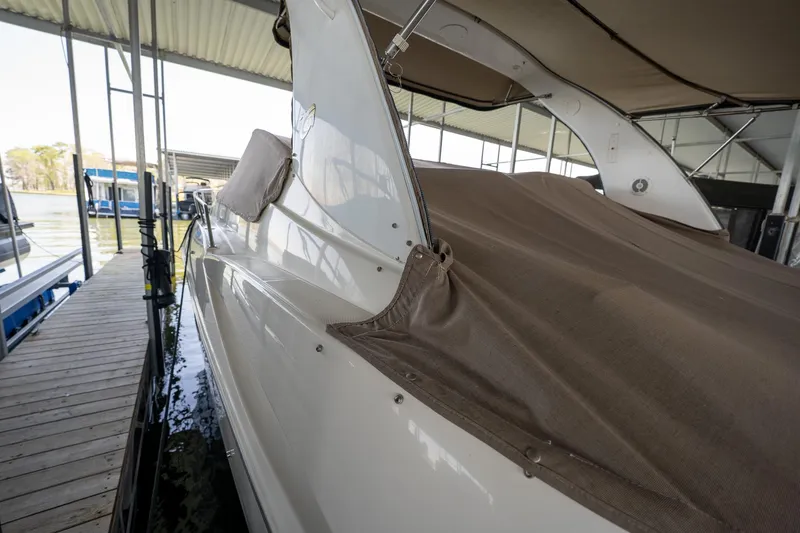 Slide: The Image of 2004 Cruisers Yachts 370 Express docked under a covered marina. - 24