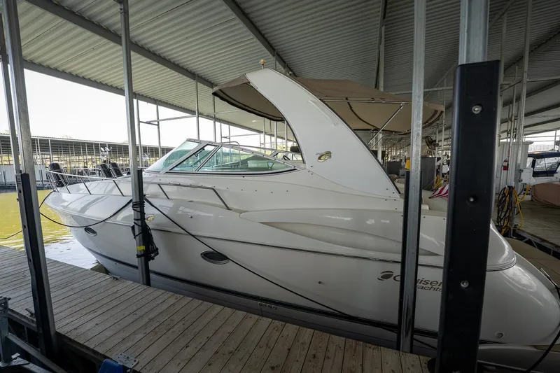 Slide: The Image of 2004 Cruisers Yachts 370 Express docked in a covered marina. - 27