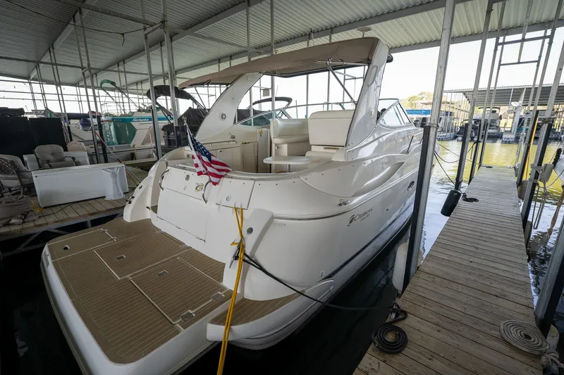 Slide: The Image of 2004 Cruisers Yachts 370 Express docked in a covered marina. - 29