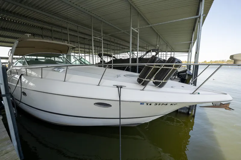 Slide: The Image of 2004 Cruisers Yachts 370 Express docked under a covered marina. - 31