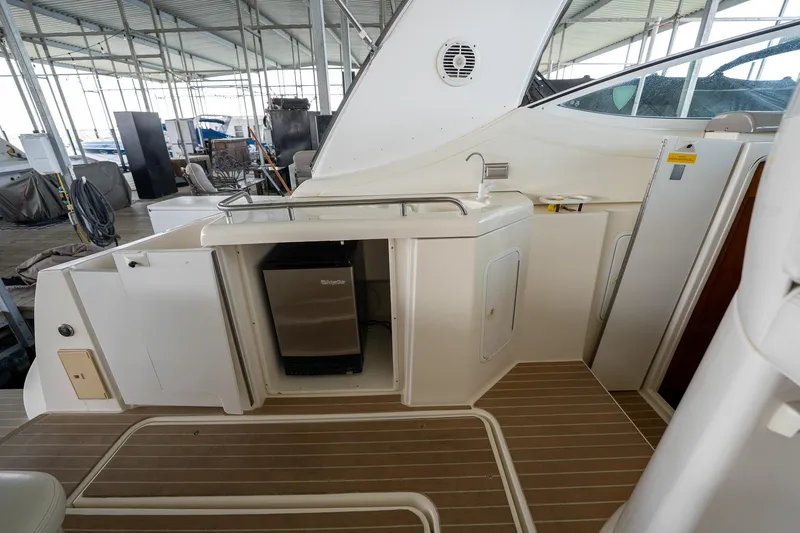 Slide: The Image of 2004 Cruisers Yachts 370 Express deck with kitchenette and storage compartments. - 44