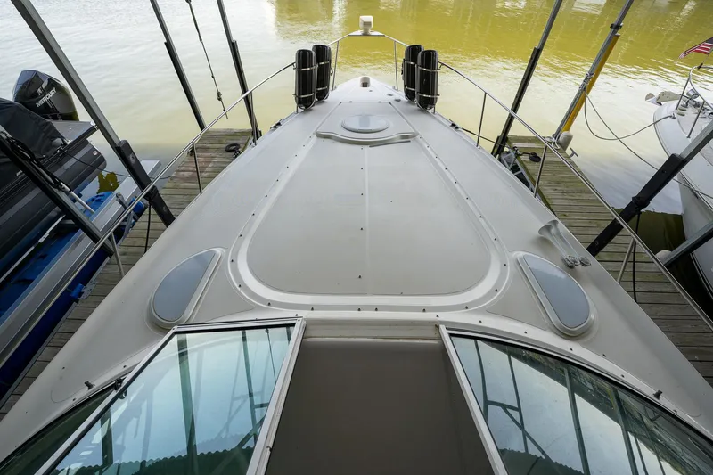 Slide: The Image of 2004 Cruisers Yachts 370 Express docked, showcasing sleek deck design and modern features. - 46