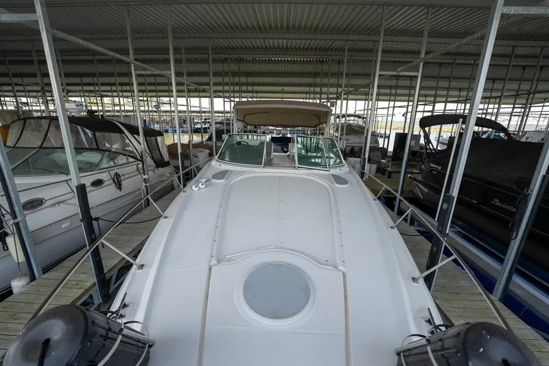 Slide: The Image of 2004 Cruisers Yachts 370 Express docked in a covered marina. - 47