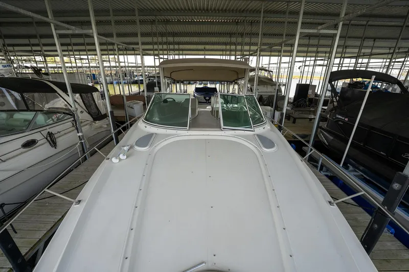 Slide: The Image of 2004 Cruisers Yachts 370 Express docked in a covered marina. - 48