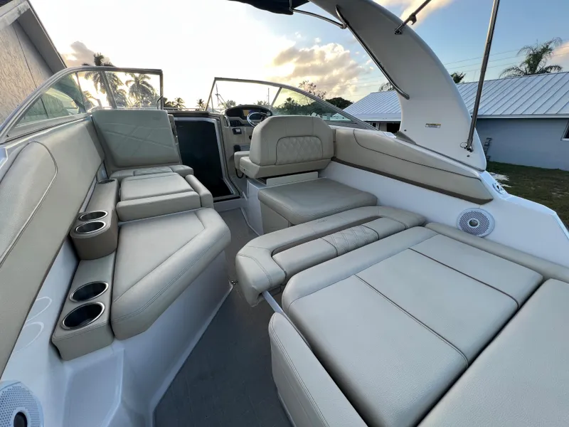 Slide: The Image of 2020 Regal 26 XO boat interior with beige seating and cup holders. - 17