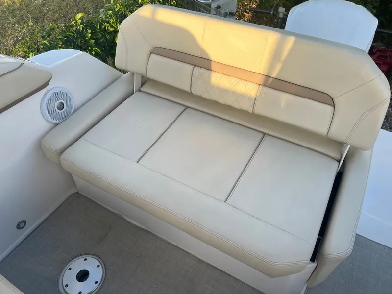 Slide: The Image of 2020 Regal 26 XO boat with beige cushioned seating and speaker detail. - 20