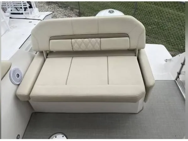 Slide: The Image of 2020 Regal 26 XO boat with beige cushioned seating and backrest. - 21